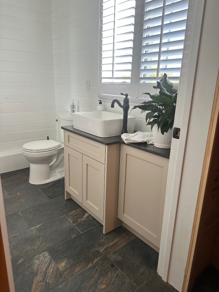 Shiplap powder room with slate floor